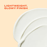 Close-up of a white cream product with 'Lightweight, Glowy Finish' text on a peach background