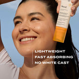 Woman applying Murad sunscreen with a clear blue sky background
